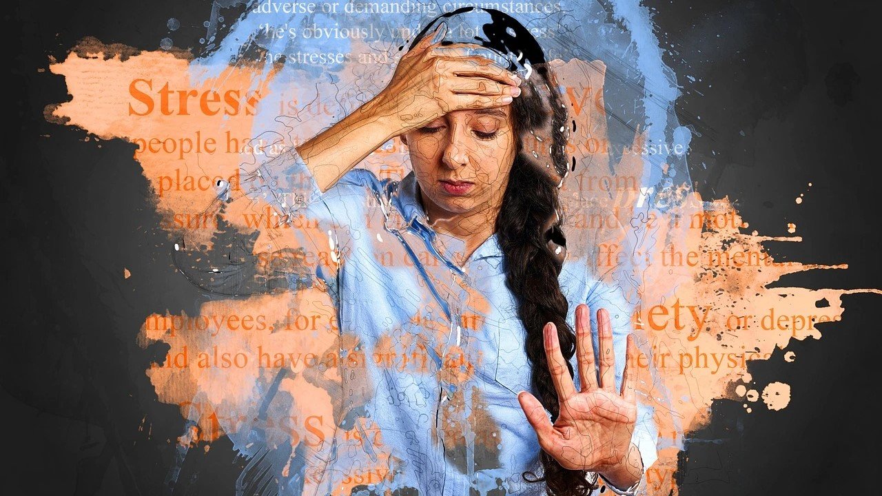 Distressed woman holding her head with abstract art and words like 'stress' and 'anxiety,' depicting the impact of emotions and asking, Can Stress and Anxiety Cause Weight Loss?