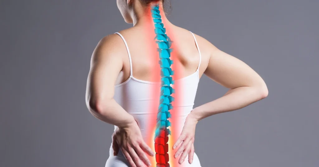 Woman holding lower back in pain with highlighted spine, illustrating the importance of strength training for injury prevention and spinal health.