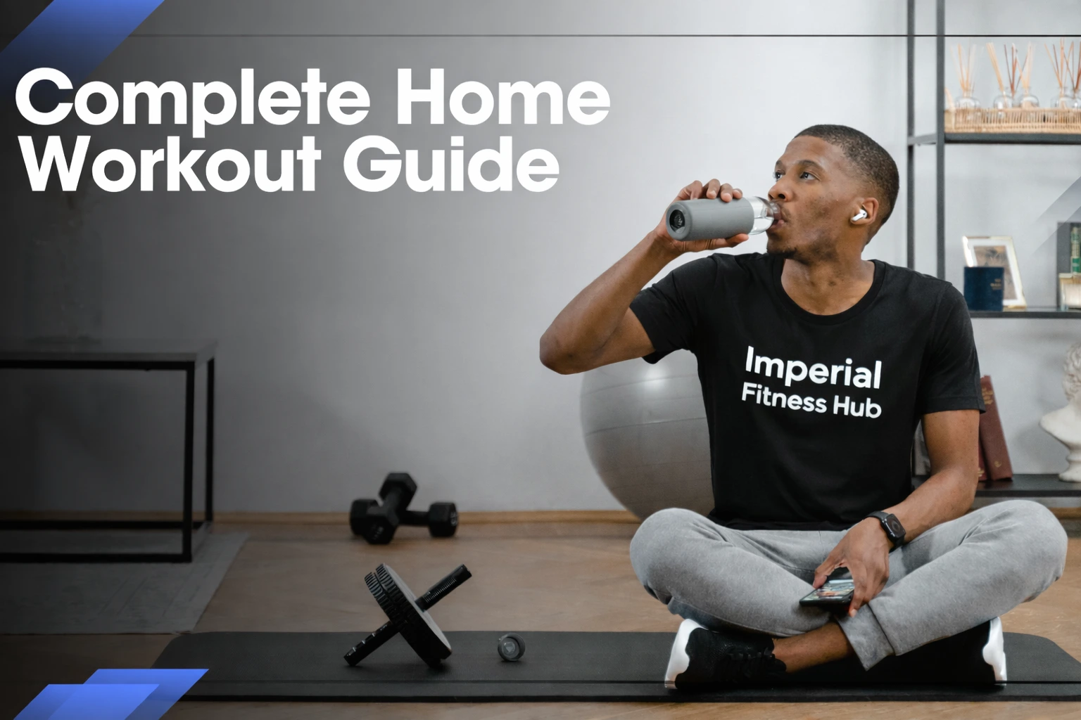 A professional fitness thumbnail showing a man sitting cross-legged on a workout mat at home, drinking from a water bottle while holding a smartphone. He is wearing a black athletic t-shirt with “Imperial Fitness Hub” printed clearly on the front. The background includes dumbbells, an ab roller, and a shelf with decor. On the left side, bold text reads “Complete Home Workout Guide” against a dark gradient for strong visual contrast.